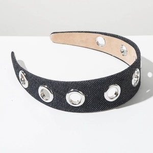 Close-up of wide denim headband with silver metal grommets and smooth inner lining