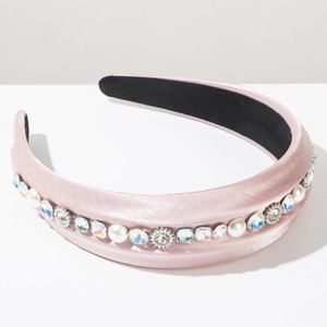 Detailed view of light pink satin headband with inlaid pearls and sparkling rhinestones