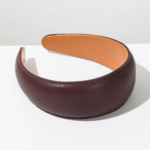 Detailed view of wide padded headband featuring textured brown lychee pattern leather