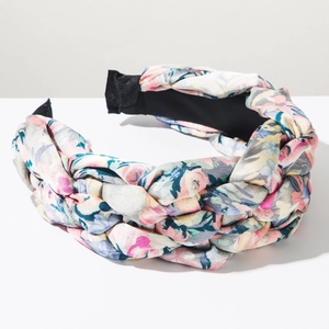 Detail of wide braided floral headband with colorful pattern and thick weave texture