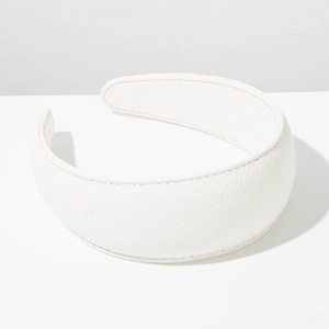 Detail of white wide leather headband featuring lychee texture and orange stitching