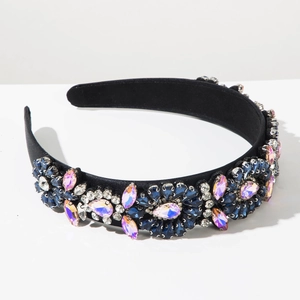 Détail du serre-tête baroque avec strass bleus et roses sur du satin noir élégant