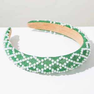 Close-up of green mesh headband with white faux pearls in diamond grid pattern
