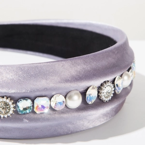 Detailed macro view of lavender satin headband with elegant pearls and sparkling rhinestones