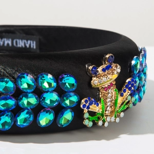 Detail of handmade black satin headband with turquoise gems and a rhinestone frog