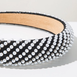 Close-up of luxury pearl headband with black bead base and soft suede lining