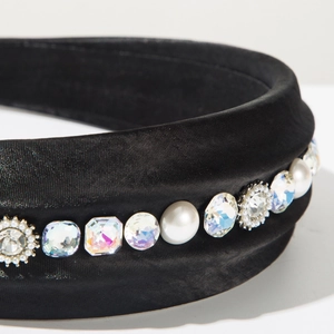 Detail of luxury padded headband featuring sparkling crystals and elegant white pearls