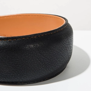 Detail of black lychee leather headband with contrast orange stitching and lining