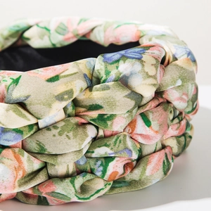Detail showing the woven braided structure and floral satin texture of the headband