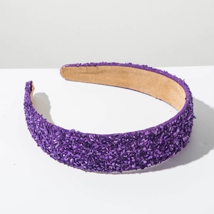 Gros plan détaillé d'un serre-tête large violet avec des textures de pierres brillantes