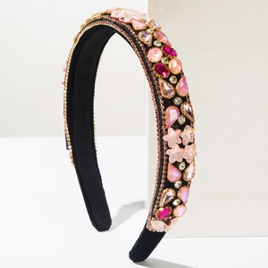 Close-up of pink crystal stars and rhinestones on luxury black velvet headband