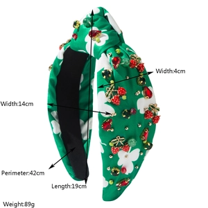 Detail view showing dimensions of a green floral headband with crystal cherry accents