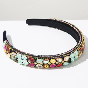 Detailed close-up of Baroque style headband with colorful rhinestones on black velvet