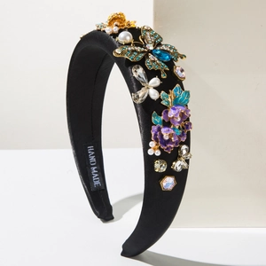 Detail of handmade baroque headband with embroidery flowers, pearls and colorful crystals