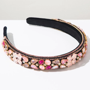 Detailed macro view of baroque star headband with pink rhinestones and velvet finish
