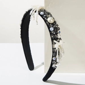 Detail of baroque velvet headband featuring sparkling crystals and woven pearl tassels