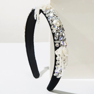 Detail showing black velvet headband with elegant pearls and sparkling rhinestones