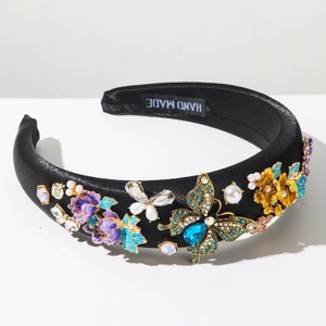 Detail showing handmade velvet headband with blue crystal butterfly and enamel flowers