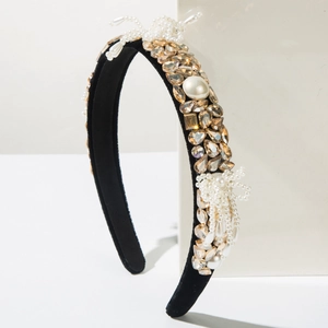 Detail of baroque headband featuring champagne crystals and white pearls on black velvet