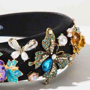 Detail of baroque headband with gold butterflies, blue crystals and pearls on black satin