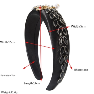 Detailed view of black satin headband with sparkling rhinestones and pearl accents