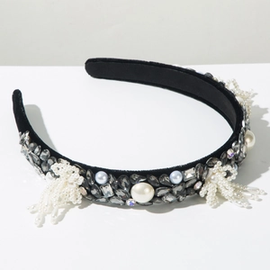Detailed shot of baroque velvet headband with rhinestones, pearls and beaded bow accents