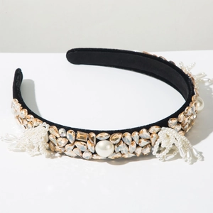 Macro view of velvet headband with sparkling crystals, pearls, and tassel details