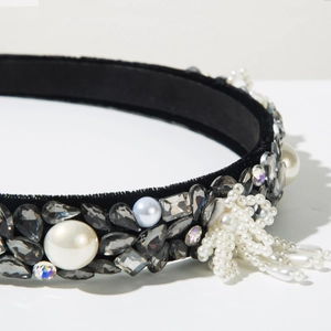 Detail of baroque black velvet headband with pearls, crystals and hanging tassel fringe