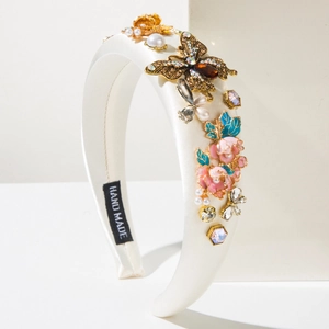 Baroque style white satin headband featuring handmade enamel flowers and gold butterflies