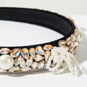Macro shot of baroque headband with rhinestones, velvet base and hanging pearls
