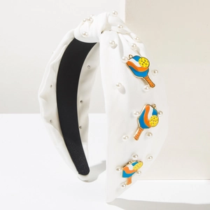 Detail of white knotted headband with imitation pearls and colorful pickleball racket charms