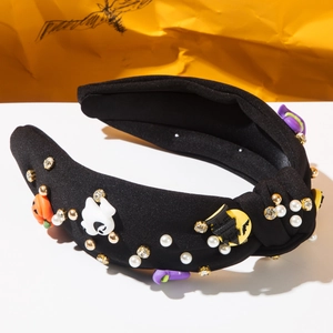 Close-up of Halloween headband featuring pearls, rhinestones, pumpkin and ghost charms