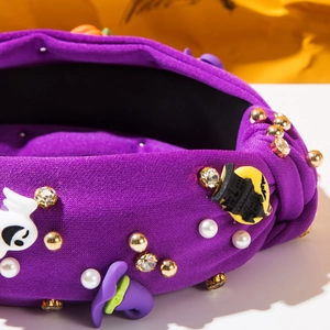 Detail of purple knotted Halloween headband with rhinestones, ghosts and wizard hat