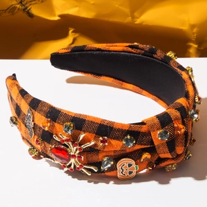 Detailed view of Halloween headband with orange plaid, rhinestone spider, and pumpkin icons