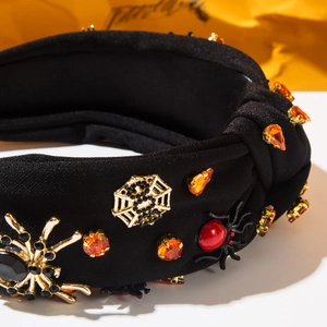 Detail of Halloween wide headband featuring rhinestone spiders and golden spiderwebs
