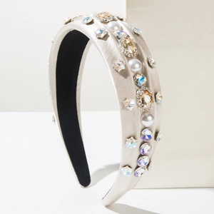 Detailed view of the wide gray satin headband with colorful rhinestones and white pearls