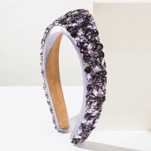 Detailed close-up of a purple baroque headband featuring crystal rhinestones and satin