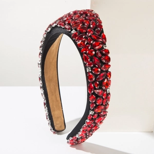 Detail of luxury baroque headband featuring red crystals on black satin finish