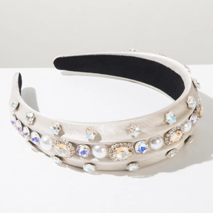 Detail of wide headband with champagne satin, white pearls and sparkling rhinestones