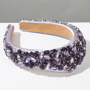 Close-up of luxury baroque headband with purple crystals on a wide satin band