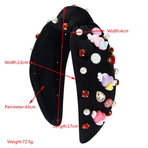 Detailed view of black knotted headband with measurements and pearl embellishments