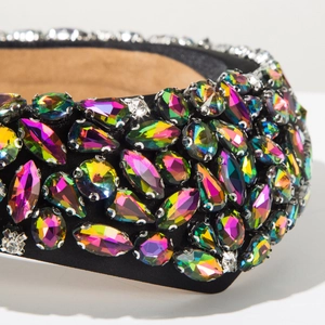 Macro detail of luxury baroque headband with multi-color rhinestones on black satin