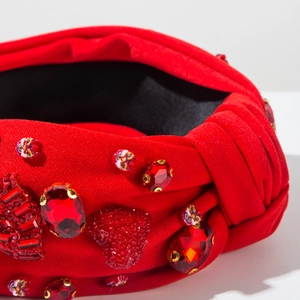 Macro shot of red knotted headband featuring faux rubies and heart-shaped sequins