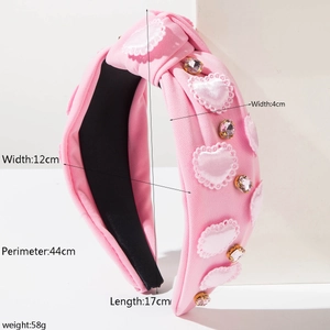 Detail of pink fabric headband with rhinestone hearts and knotted design and dimensions