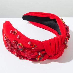 Detail showing red knotted headband with sparkling rhinestones, heart beads and gemstones