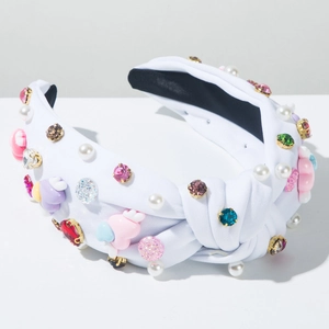 Detail of white knotted headband with colorful rhinestones, beads and heart charms