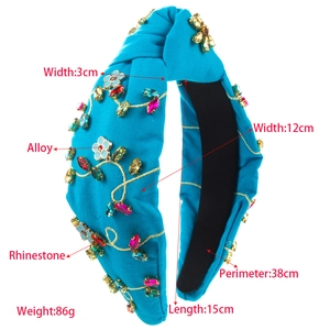 Detailed view of handmade dark blue knot headband with colorful rhinestones and crystal flowers