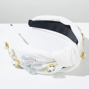 Macro detail of hand-applied crystal butterflies and gemstones on a white knotted headband