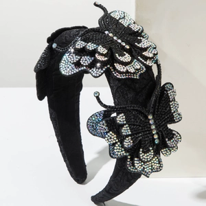 Detail of luxury padded headband featuring 3D rhinestone butterflies on black fabric