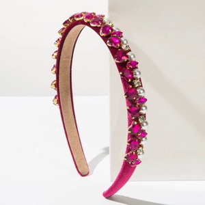 Detailed view of fuchsia velvet headband with rhinestones, pearls, and heart gems